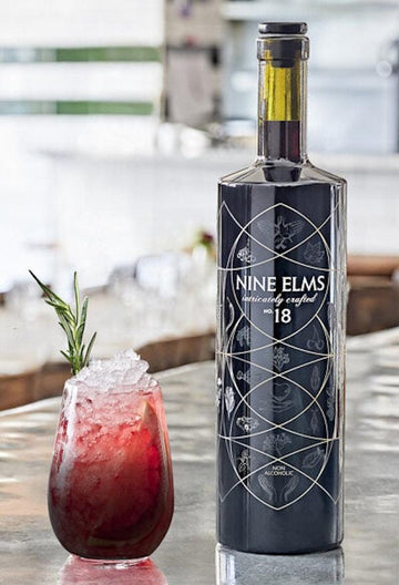 The Olson Mocktail next to a bottle of NINE ELMS No.18
