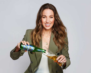 Woman drinking Heineken 0 from the bottle Sans Drinks