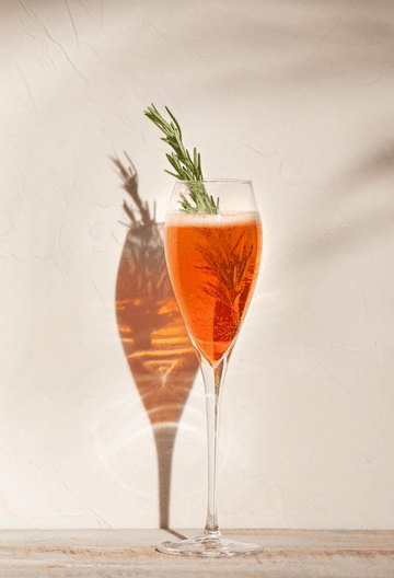 Spritz mocktail made with Wilfred's Aperitif and garnished with a sprig of rosemary
