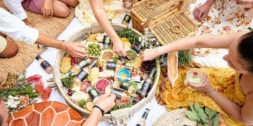 Friends enjoying a tray of food and ETCH non-alcoholic drinks Sans Drinks