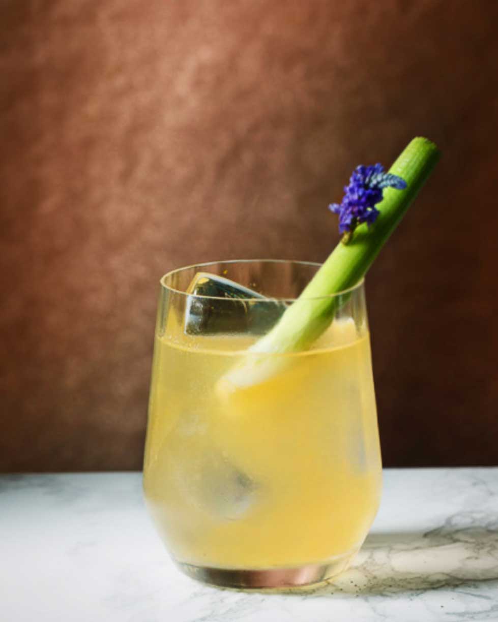 Gin mocktail garnished with fennel and edible lavender flowers