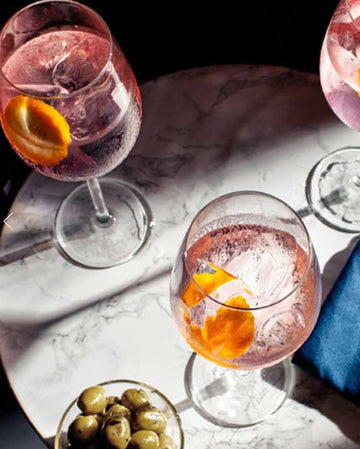 Three glasses of Pink Gin Mocktail garnished with orange slices