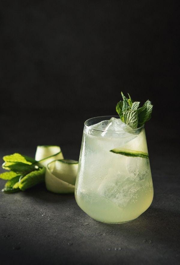 Elderflower gin mocktail garnished with mint leaves and a slice of cucumber