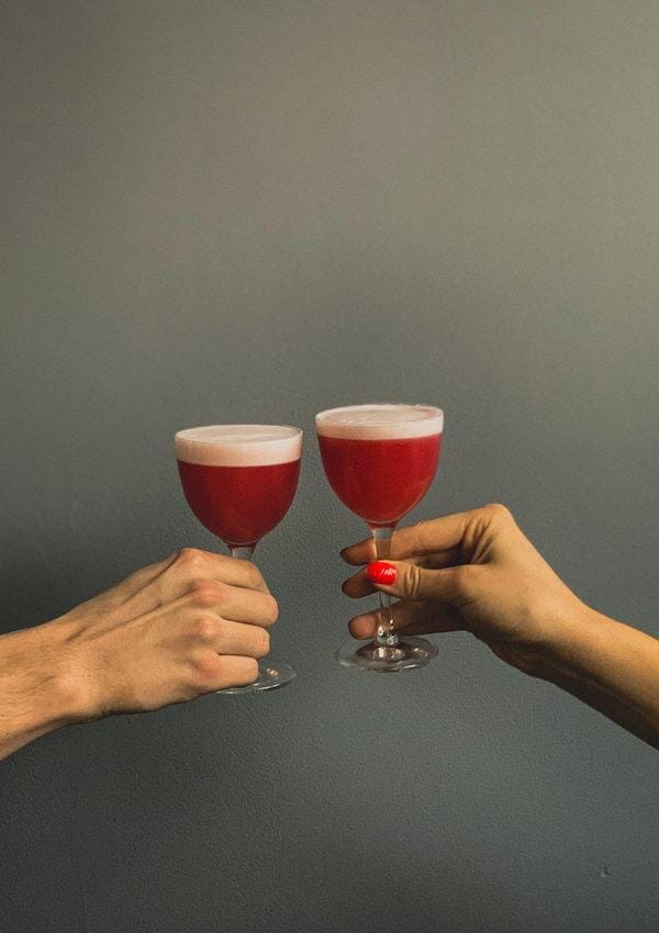 Two hands holding gin mocktails