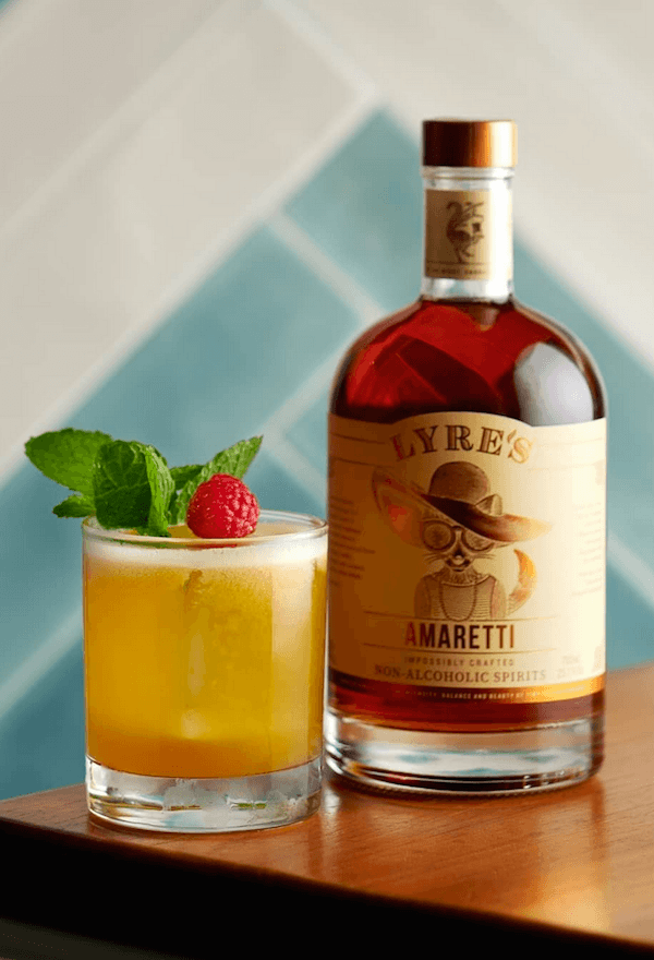 Amaretti Mocktail next to a bottle of Lyre's Amaretti