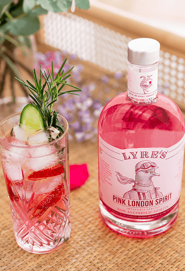 Pink Gin and Tonic mocktail next to a bottle of Lyre's Pink London Spirit