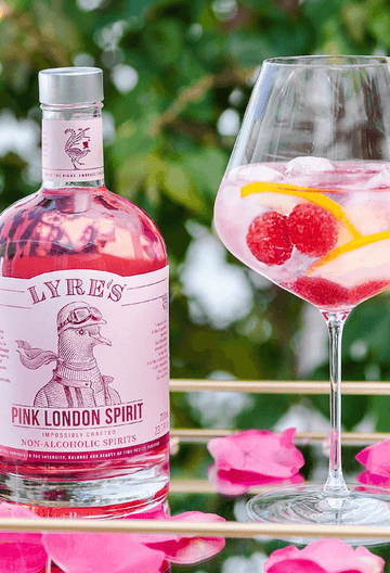 Bottle of Lyre's Pink London Spirit next to a gin spritz mocktail