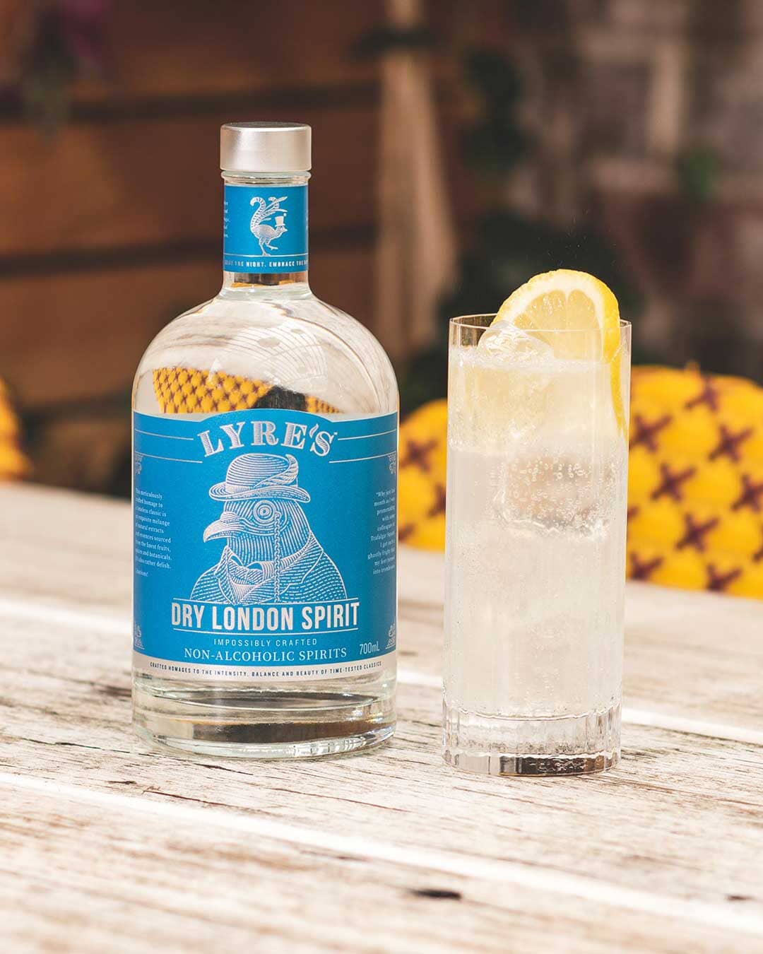 London Dry Collins Gin Mocktail next to a bottle of Lyre's Dry London Spirit Sans Drinks