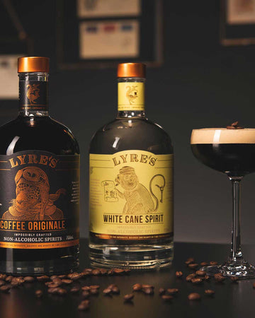 Espresso Martini Mocktail glass next to a bottle of Lyre's Coffee Originale and a bottle of Lyre's White Cane Spirit