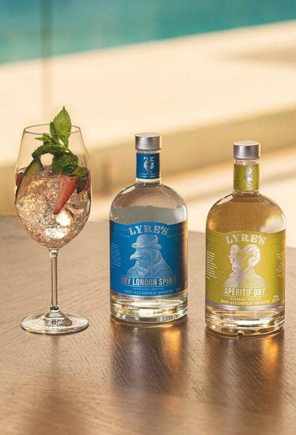 Non-alcoholic spritz next to a bottle of Lyre's dry london spirit and Lyre's aperitif spirit