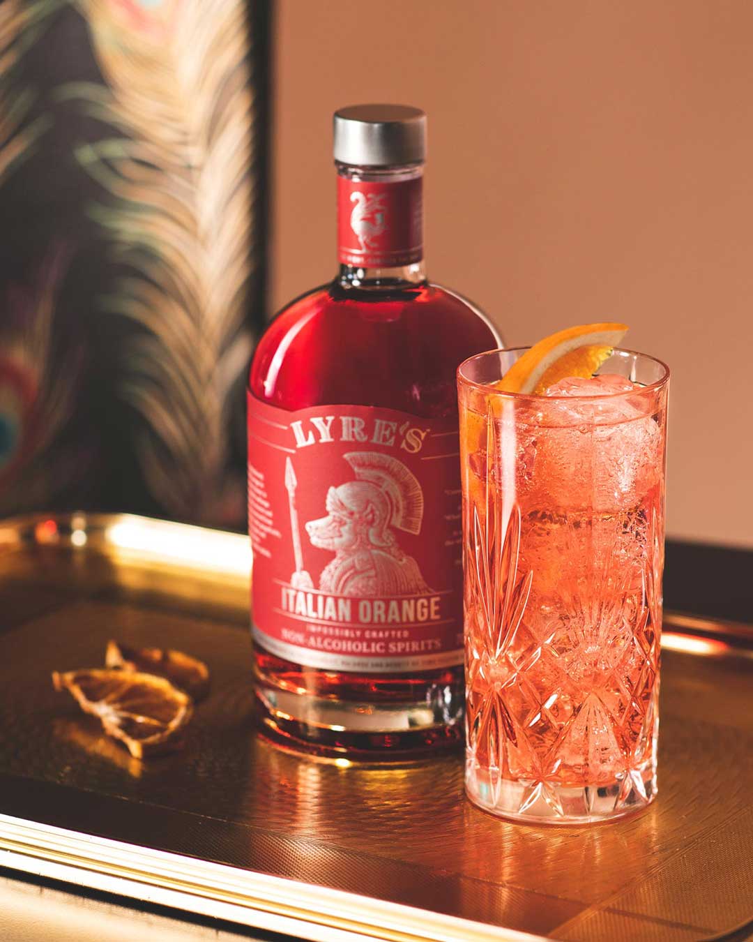 Italian orange mocktail next to a bottle of Lyre's italian orange Sans Drinks