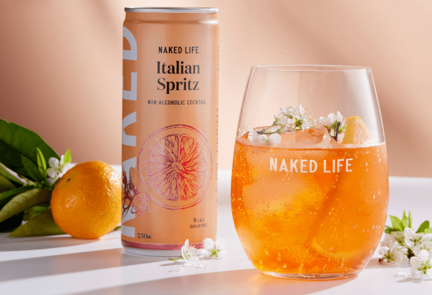A can of Naked Life Italian Spritz and a non-alcoholic italian spritz mockail