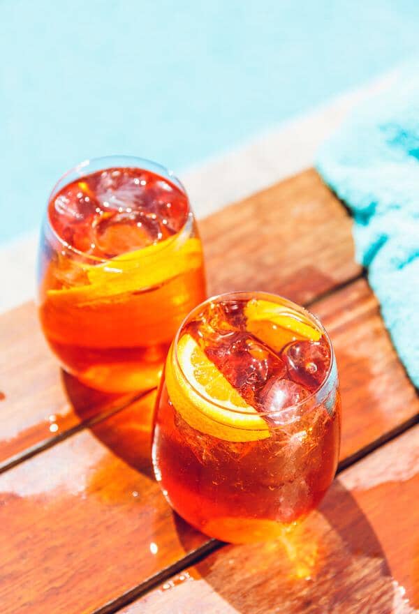 Two non-alcoholic spritz made with Sans Bar Spritzing in Venice and garnished with orange slices