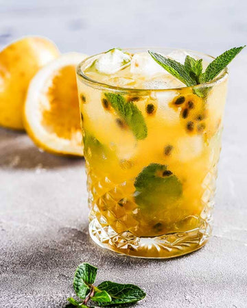 Passion Fruit Mojito Mocktail made with Sans Bar Sans Bar Summer Carnivàle (White Rum Substitute) and garnished with mint leaves