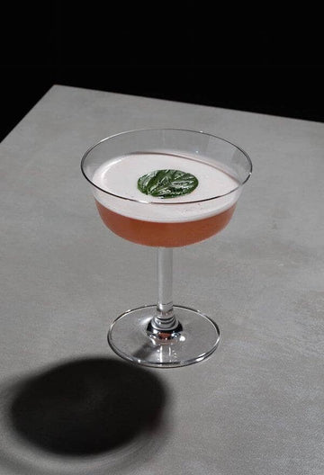 Mocktail garnished with basil leaf and made with ovant verve