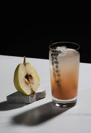 Non-alcoholic mocktail made with Ovant grace and garnished with thyme sprig Sans Drinks