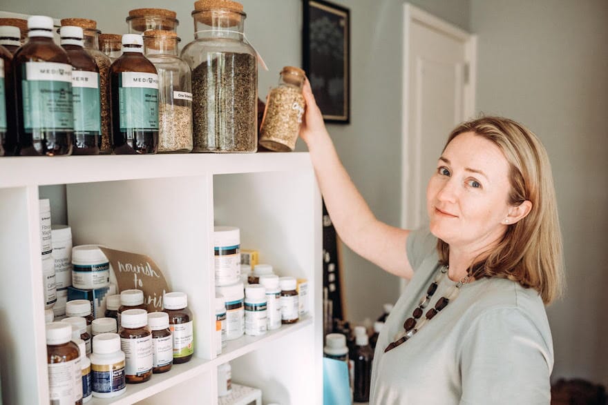Rachel Aldridge holding a jar with herbs 