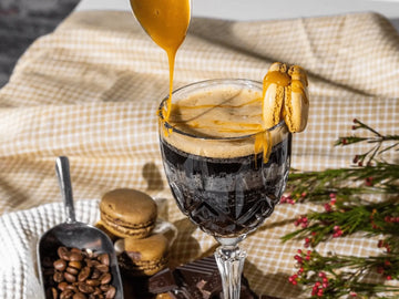 A spoon filled with salted caramel drizzling over a Espresso Martini Mocktail made with