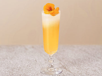 Non-alcoholic mimosa made with Seedlip grove 42 and garnished with edible flowers