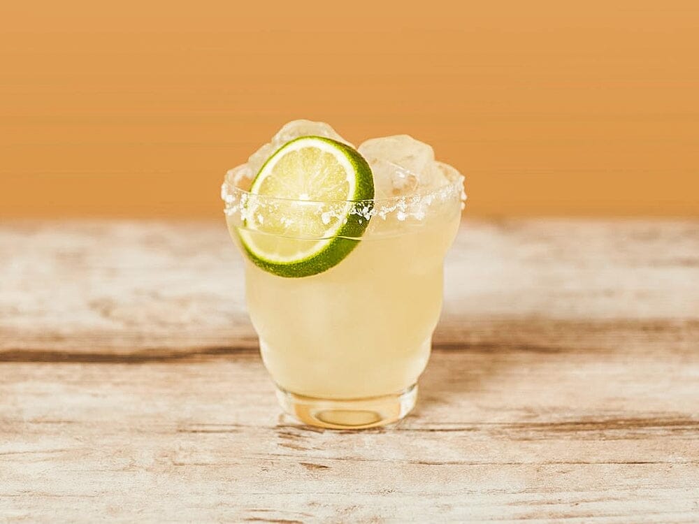 Margarita Mocktail made with seedlip grove 42 and garnished with lime wheels Sans Drinks