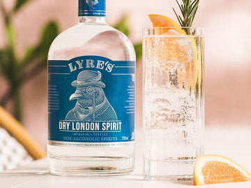 Bottle of Lyre's London Dry Spirit next to Gin and Tonic mocktail