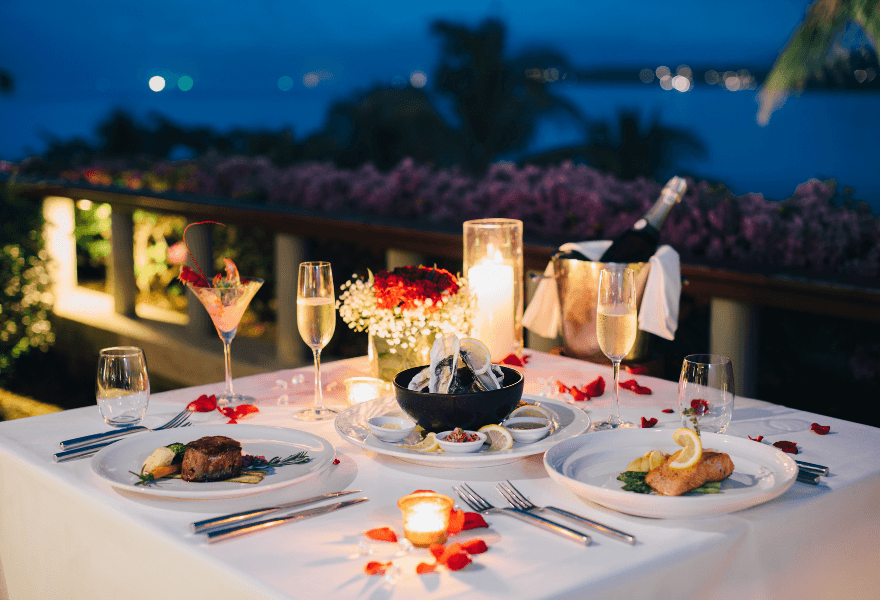 A valentines day dinner table set up with non-alcoholic champagne