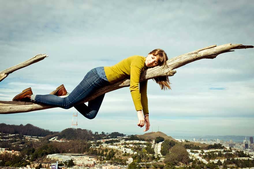 A woman on a tree branch Sans Drinks
