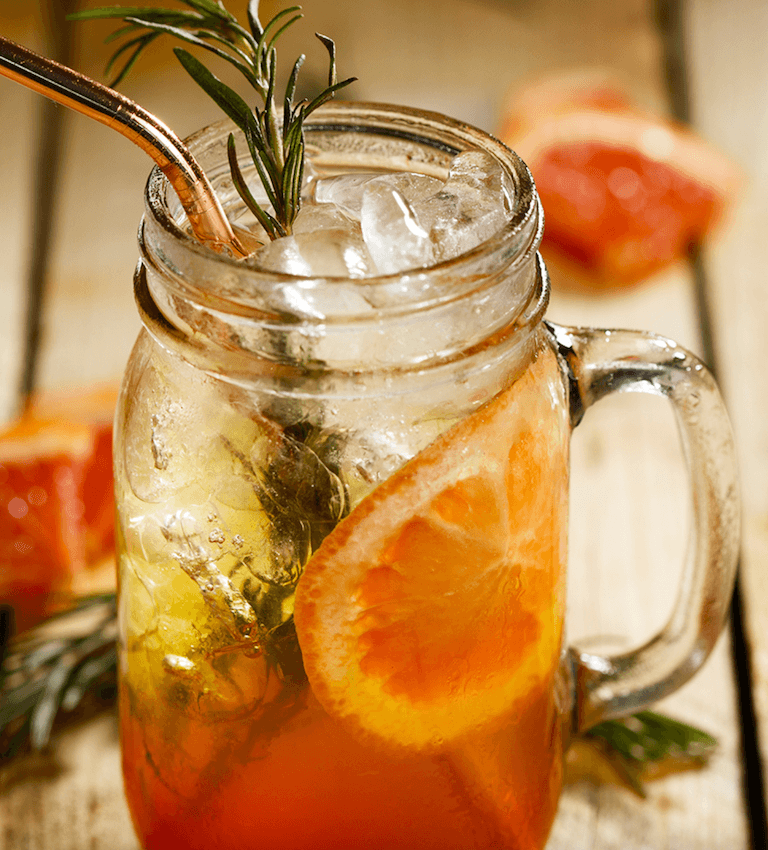 Claytons Made in Barbados in a mason jar garnished with rosemary sprig and grapefruit wheels