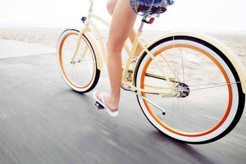 A women riding a bike Sans Drinks