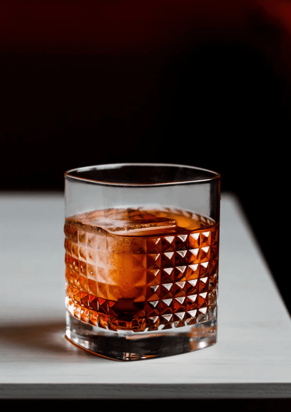 Negroni Mocktail in a rock glass with a clear ice block