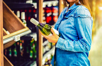 A women holding a bottle of non-alcoholic wine