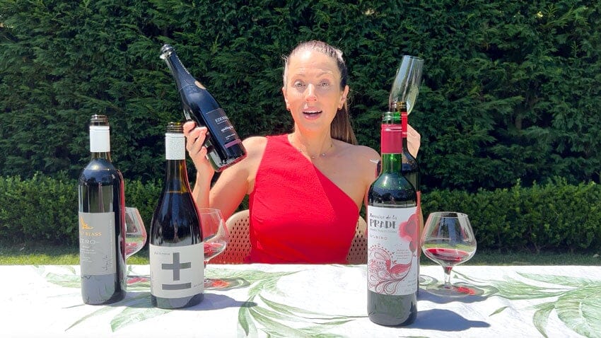 Irene Falcone holding two bottles of non-alcoholic wine 
