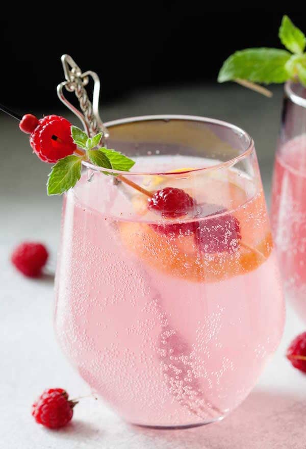 Pink Virgin Tom Collins made with Ms Sans Cherry Blossom Blush and garnished with fresh raspberries 