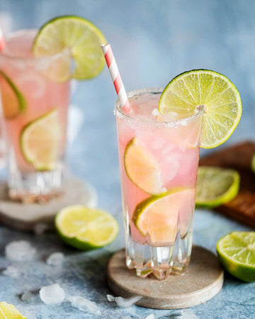 Pink Mocktail garnished with lime wheels and made with Ms Sans Cherry Blossom Blush Sans Drinks