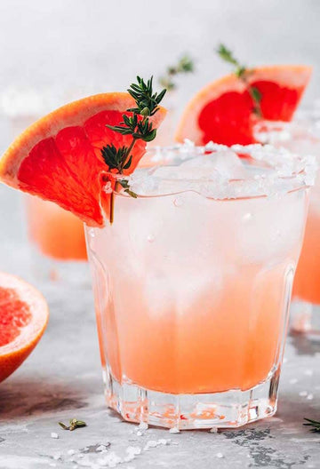 Salty Dog Mocktail made with Ms Sans Make me A Martini (Non-Alcoholic Vodka) and garnished with grapefruit slices Sans Drinks