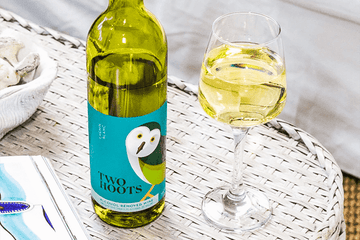 Two hoots non-alcoholic white wine bottle and wine glass