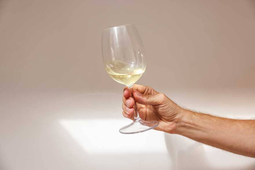 Hand holding a glass of non-alcoholic wine